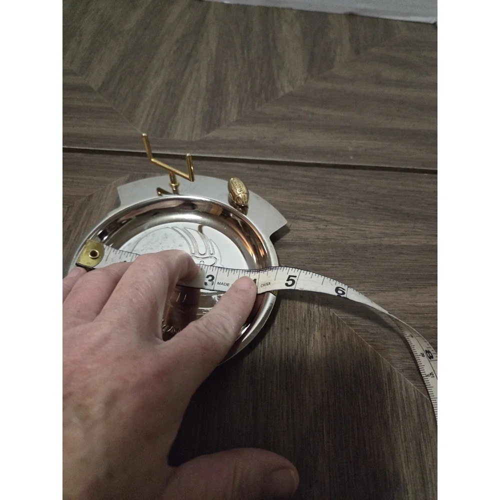 silver-tone and brass football 